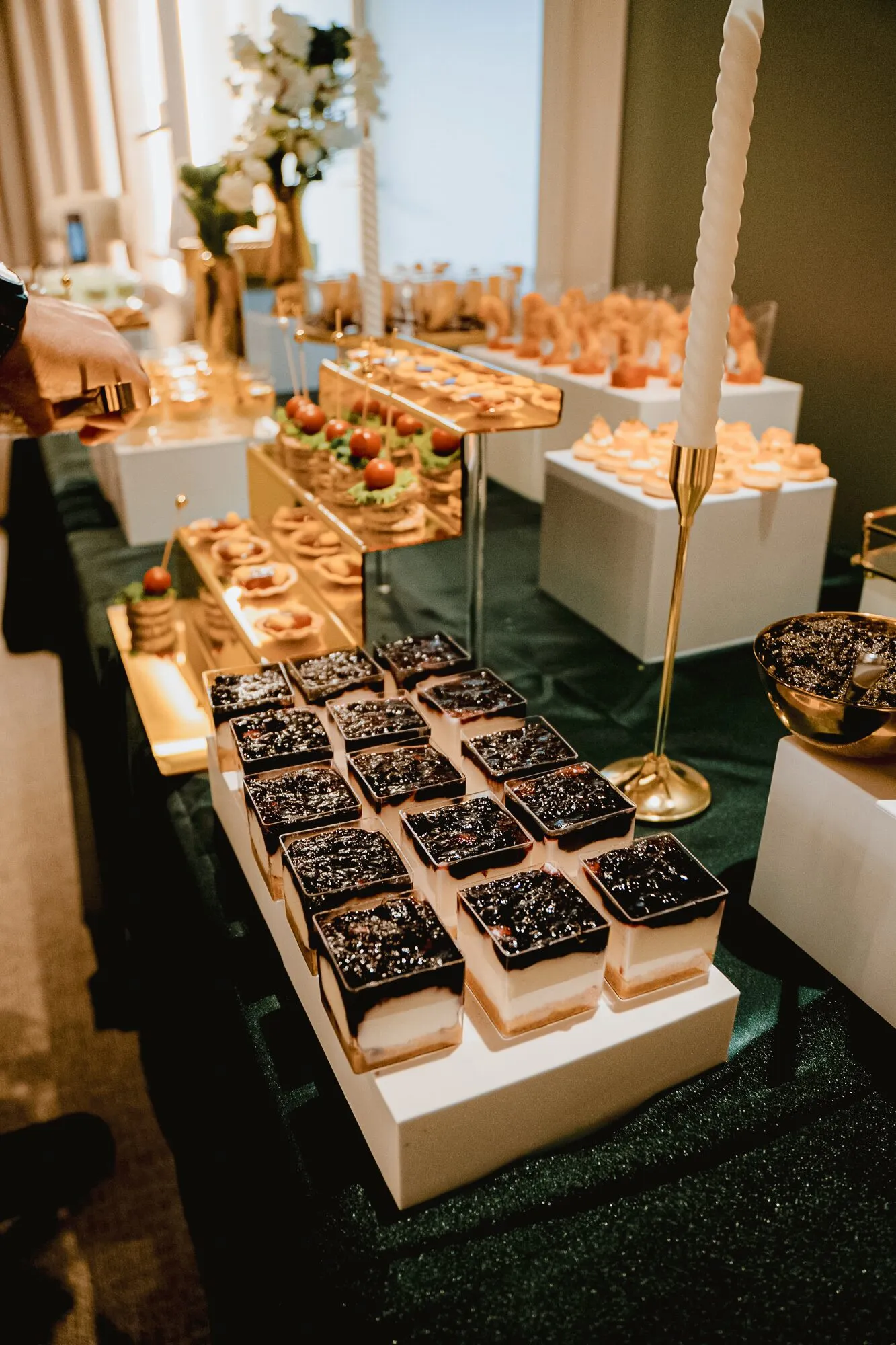 Mesa de buffet noturna com copos de sobremesa em cubos brancos